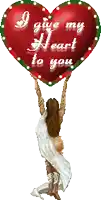 a woman is holding up a heart that says i give my heart to you