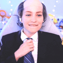 a woman in a suit and tie with a bald head on her head