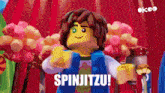 a lego character is dancing with the words spinjitzu on the bottom
