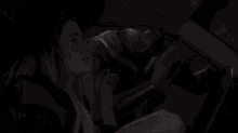 a woman is sitting in the back seat of a car with a bloody hand