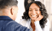 a man and a woman are looking at each other and smiling