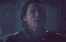a close up of a man 's face in a dark room in a movie .