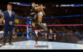 a woman in a wrestling ring is jumping in the air with the words music written below her
