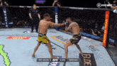two men are fighting in a boxing ring with a monster energy logo on the corner