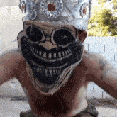 a man wearing a skull mask and a crown on his head