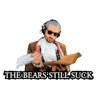 a man in a suit holding a book with the words " the bears still suck " below him
