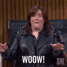 a woman in a leather jacket is making a woow gesture
