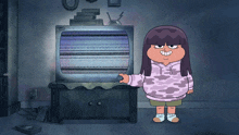 a girl in a purple sweatshirt stands in front of a tv with a static screen