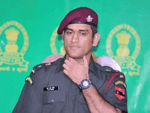a man in a military uniform has a watch on his arm
