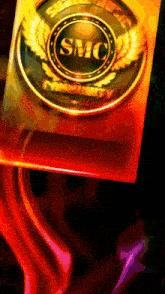 a smc logo is on a red and orange background