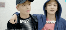 two young men are standing next to each other and one has the word cande on his sweatshirt