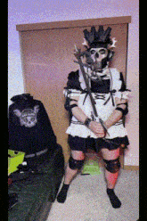 a person dressed as a maid with a skull mask on