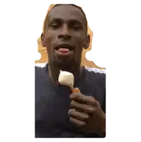 a man is eating an ice cream cone with his tongue hanging out
