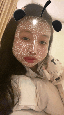 a girl with a mask on her face and a shirt that says ' snoopy ' on it