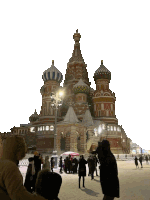 a group of people are standing in front of a large building with a blue dome on top