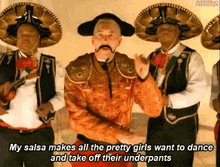 a man with a mustache is dancing in front of a group of mariachi singers .