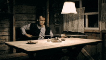 a man sitting at a table with a gun