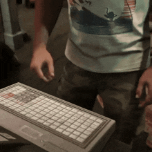 a person standing next to a keyboard that says ' lg ' on it
