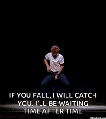 a man is standing on a stage with his legs crossed and a quote on it .