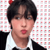 a young man wearing a cherry on his head is making a funny face