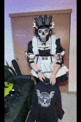 a man in a maid outfit is standing next to a black shirt with a skull on the back