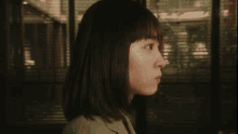 a woman with short hair is smiling with her eyes closed