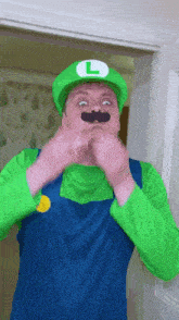 a man in a luigi costume is making a face