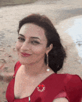 a woman wearing a red dress has a sticker on her chest that says just love