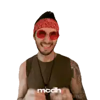 a man wearing red sunglasses and a bandana with the word mcdh on his shirt