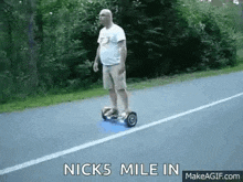 a man is riding a hoverboard on the side of the road .