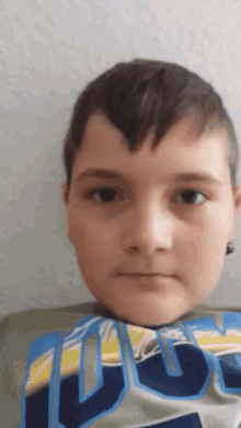 a young boy wearing a shirt that says ucsd on it