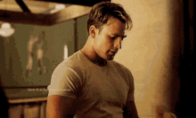 captain america is wearing a white t-shirt and standing in a room .