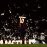 a soccer player wearing a number 10 jersey is being tackled by another player