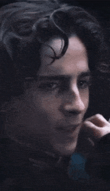 a close up of a man 's face with a woman 's hand on his chin .