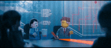 two lego figures are sitting at a table in front of a screen with chinese characters on it