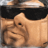 a close up of a face in a jar of liquid