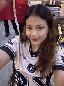 a woman wearing a black and white shirt with the number 24 on the front