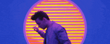 a man is dancing in front of a neon circle .