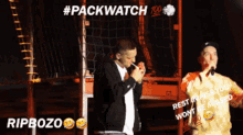 a man smoking a cigarette next to a man singing into a microphone with #packwatch written on the bottom