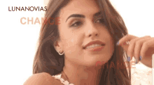 a close up of a woman 's face with the word lunanovias written on the bottom .