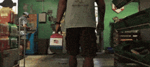 a man carrying a cooler in a store with a shirt that says ' jackson county ' on the front