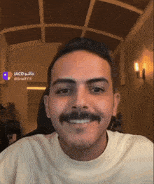 a man with a mustache is smiling in front of a sign that says jaco @ snail111