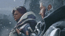 a man and a woman are standing next to each other in a snowy area .