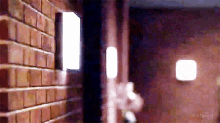 a blurry picture of a brick wall with a light on the side