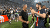two men on a soccer field with canal + in the upper right corner