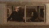 two women are looking out a train window