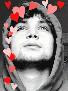 a black and white photo of a man with hearts surrounding his face