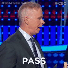a man in a suit and tie is saying pass on a television show