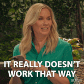 a woman in a green shirt is holding a cell phone and says it really doesn 't work that way