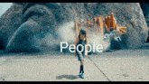 a little girl is standing in front of a giant monster with the word people written on the bottom